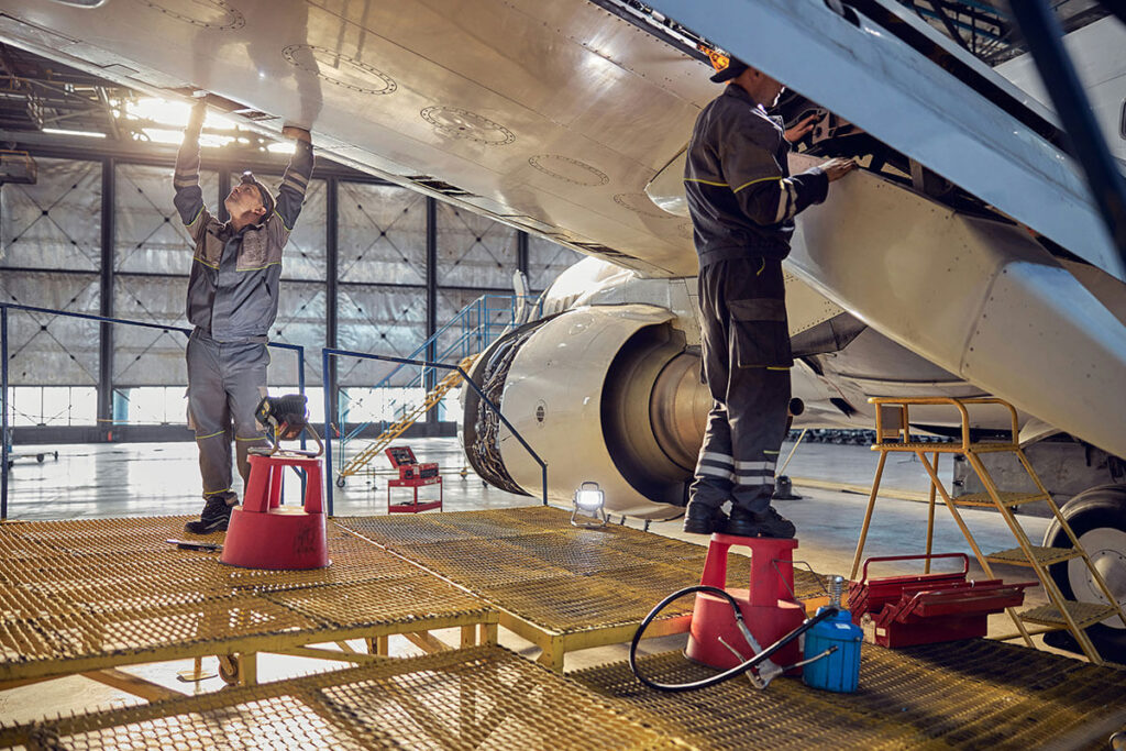Two men inspecting a plane.