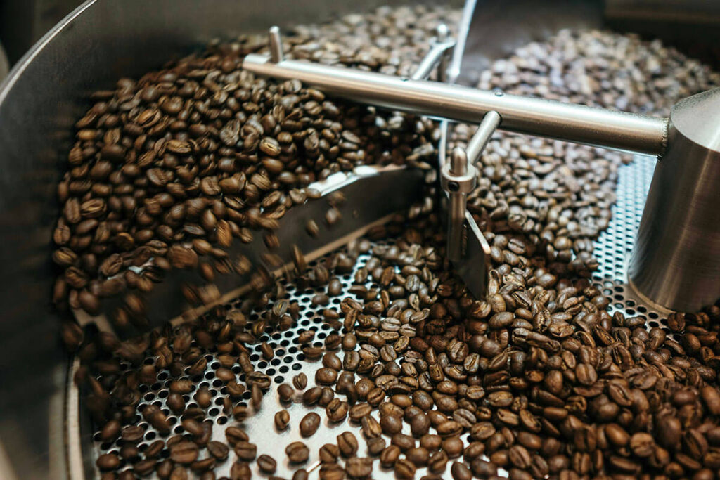 Coffee beans in grinder.